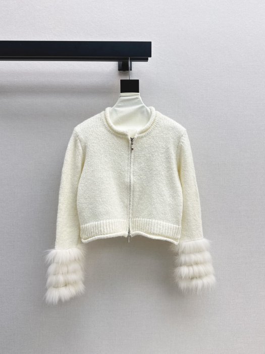 Knitted pullover on lightning from fur foxes