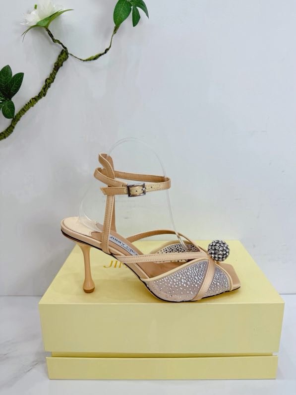 Sandals on stud from crystals and decorative ball on wear from strap on ankle