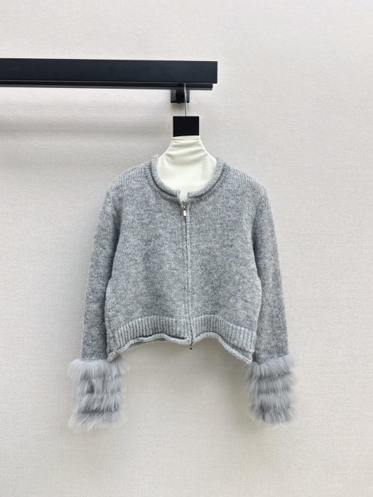 Knitted pullover on lightning from fur foxes